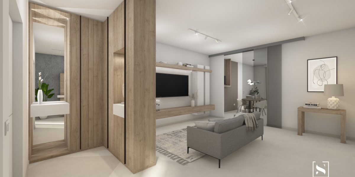 Questa immagine mostra un progetto di interior design contemporaneo, caratterizzato da un ingresso multifunzionale con pannelli in legno chiaro che incorporano nicchie decorative e uno specchio, creando una transizione armoniosa verso il soggiorno. L'area living è arredata con un divano grigio e un mobile TV sospeso, mantenendo uno stile pulito e moderno. L'illuminazione strategica con faretti incassati esalta l'ambiente, mentre l'uso di colori neutri conferisce un'atmosfera elegante e accogliente. L'attenzione ai dettagli e l'uso di materiali di alta qualità riflettono un design sofisticato e funzionale, perfetto per spazi contemporanei