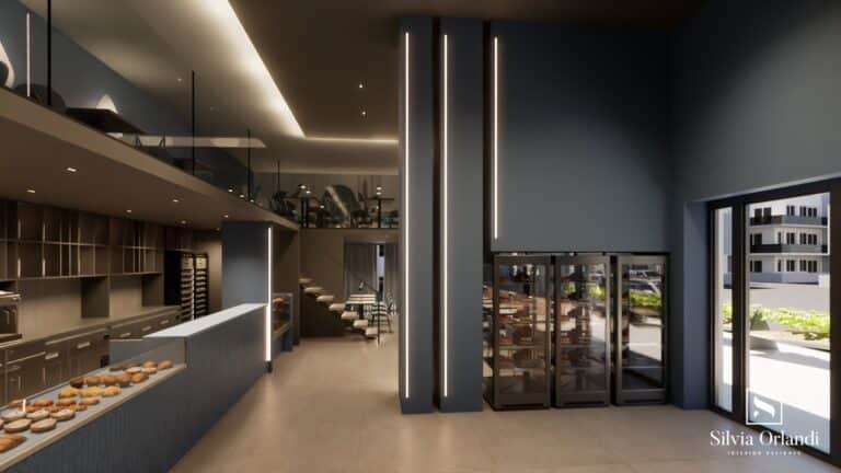 Interni del bar blu intenso con banco espositivo, vetrine refrigerate per dolci, pareti blu con illuminazione LED verticale e soppalco arredato per la consumazione. Progetto di interior design firmato Silvia Orlandi.