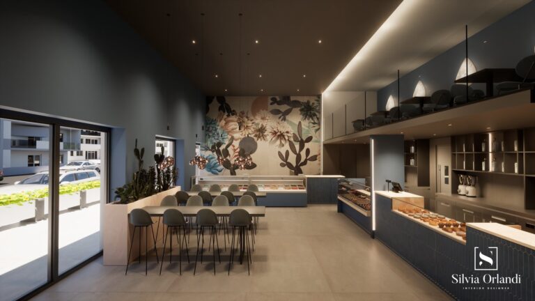 Interni del bar blu intenso, con grandi vetrate, tavoli sociali con sedute alte, pareti blu e decorazioni floreali maxi, banco con dolci e gelati artigianali. Progetto firmato Silvia Orlandi Interior Designer.