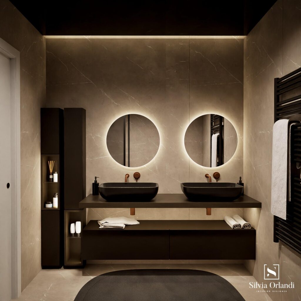 Bagno da interio design contemporaneo elegante con doppio lavabo nero su piano sospeso, rivestimenti effetto marmo beige, specchi rotondi retroilluminati e illuminazione calda integrata, arredi minimal in legno scuro e dettagli in acciaio.