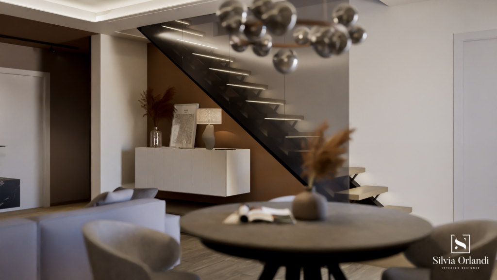 Zona living contemporanea con scala a vista sospesa in metallo e gradini retroilluminati, madia minimal sospesa, tavolo rotondo con sedute imbottite e palette calda nei toni beige e terracotta.