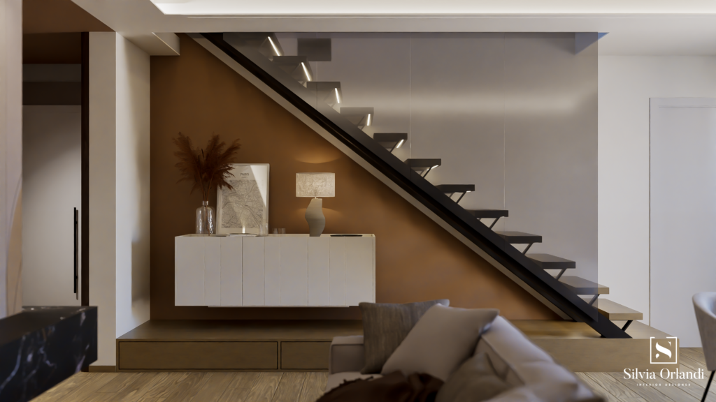 Scala contemporanea a giorno con struttura in metallo nero e gradini sospesi retroilluminati, parete d’accento color terracotta e madia minimal sospesa con decorazioni neutre.