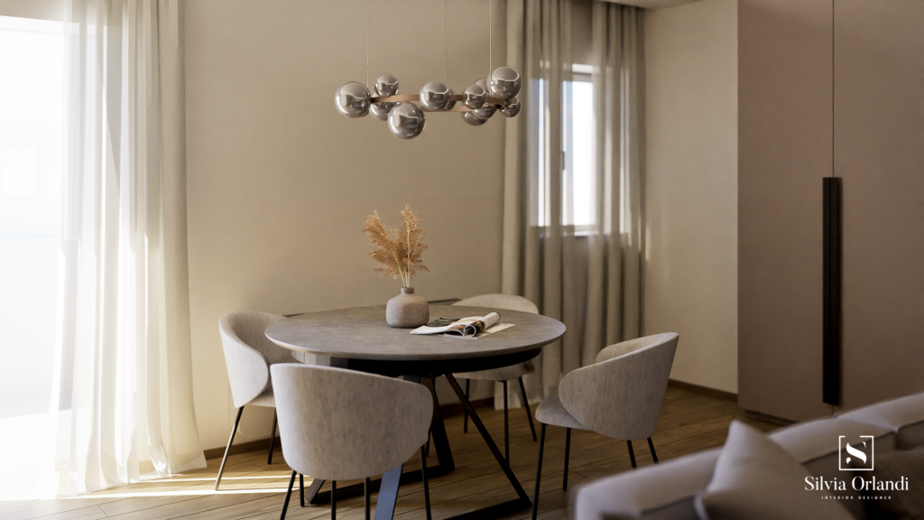 Zona pranzo in stile interio design contemporaneo con tavolo rotondo in finitura materica, sedie imbottite dai toni neutri, lampadario a sospensione con sfere in vetro, tende leggere filtranti e palette calda ed elegante.